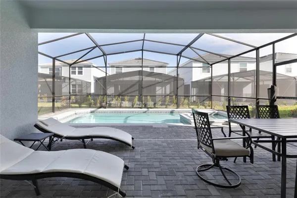 a living room with a table a table and chairs