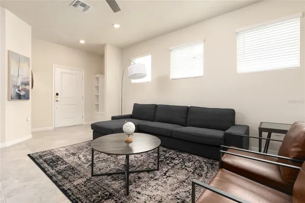 a living room with furniture and a rug