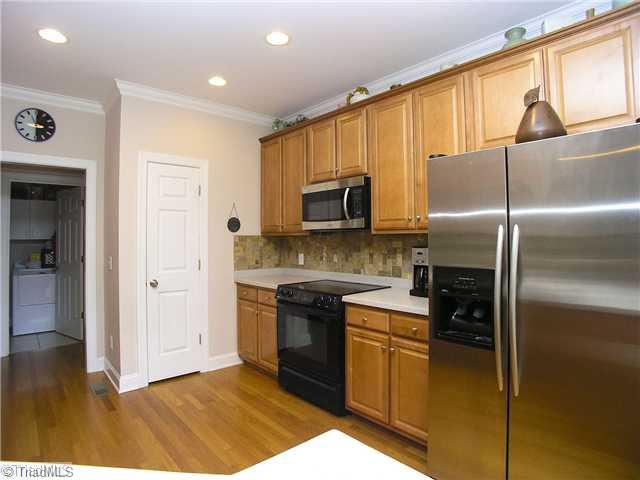 6004 Chalet Drive Oak Ridge, NC 27310 - Photo 2 of 16 Kitchen. Another View of Kitchen: note recessed lighting, crown molding, gorgeous hardwood flooring and lots of cabine space!