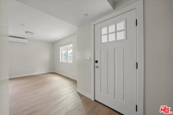 a view of kitchen with stainless steel appliances refrigerator oven and cabinets
