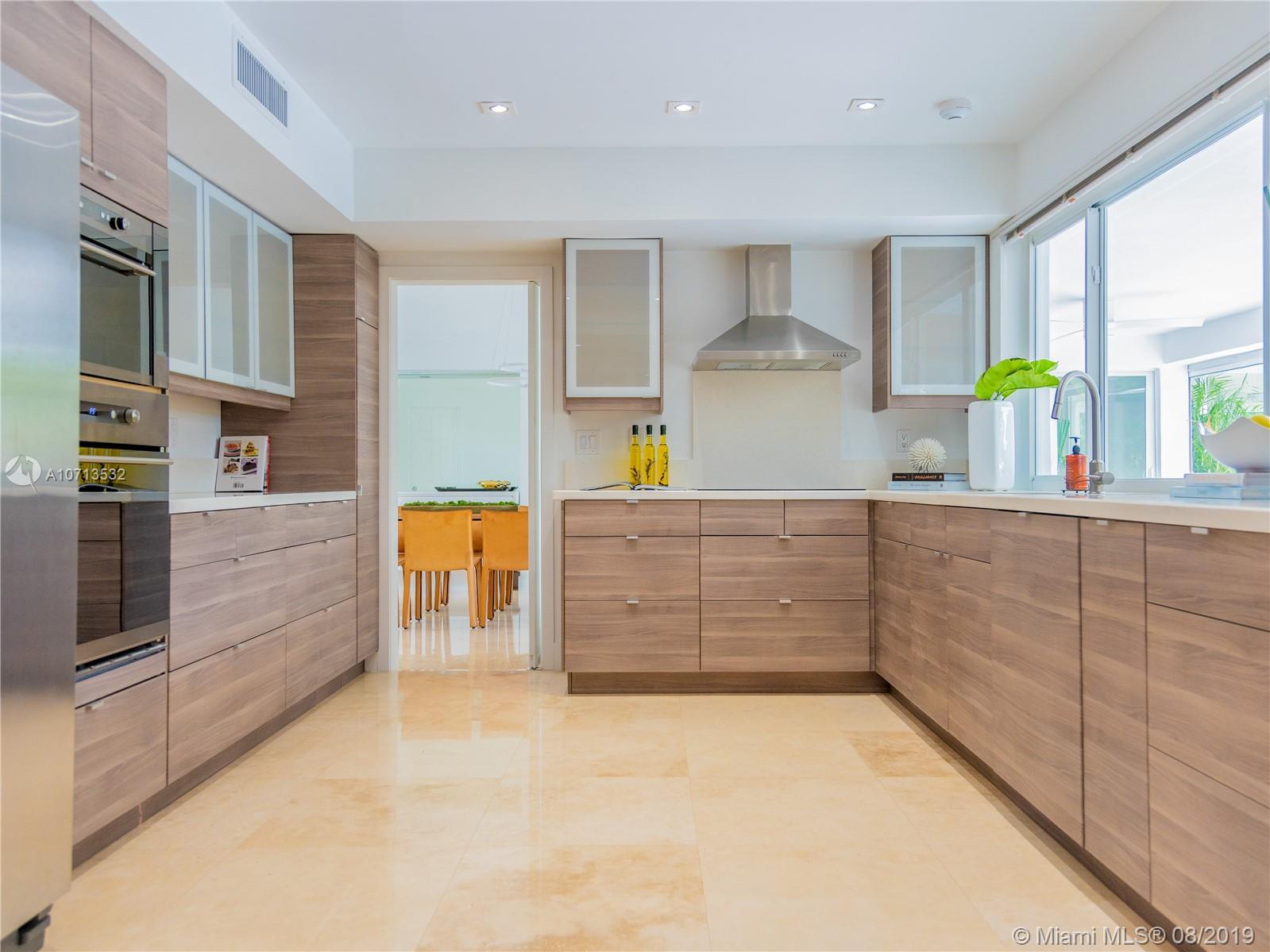 4765 Lake Road Miami, FL 33137 - Photo 17 of 30 a kitchen with stainless steel appliances granite countertop a sink and counter space