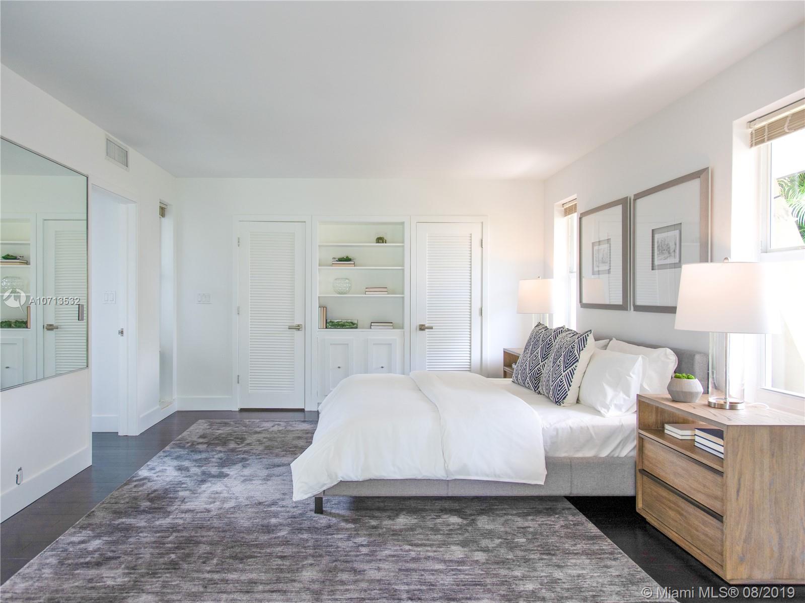 4765 Lake Road Miami, FL 33137 - Photo 20 of 30 a bedroom with a bed and a couch