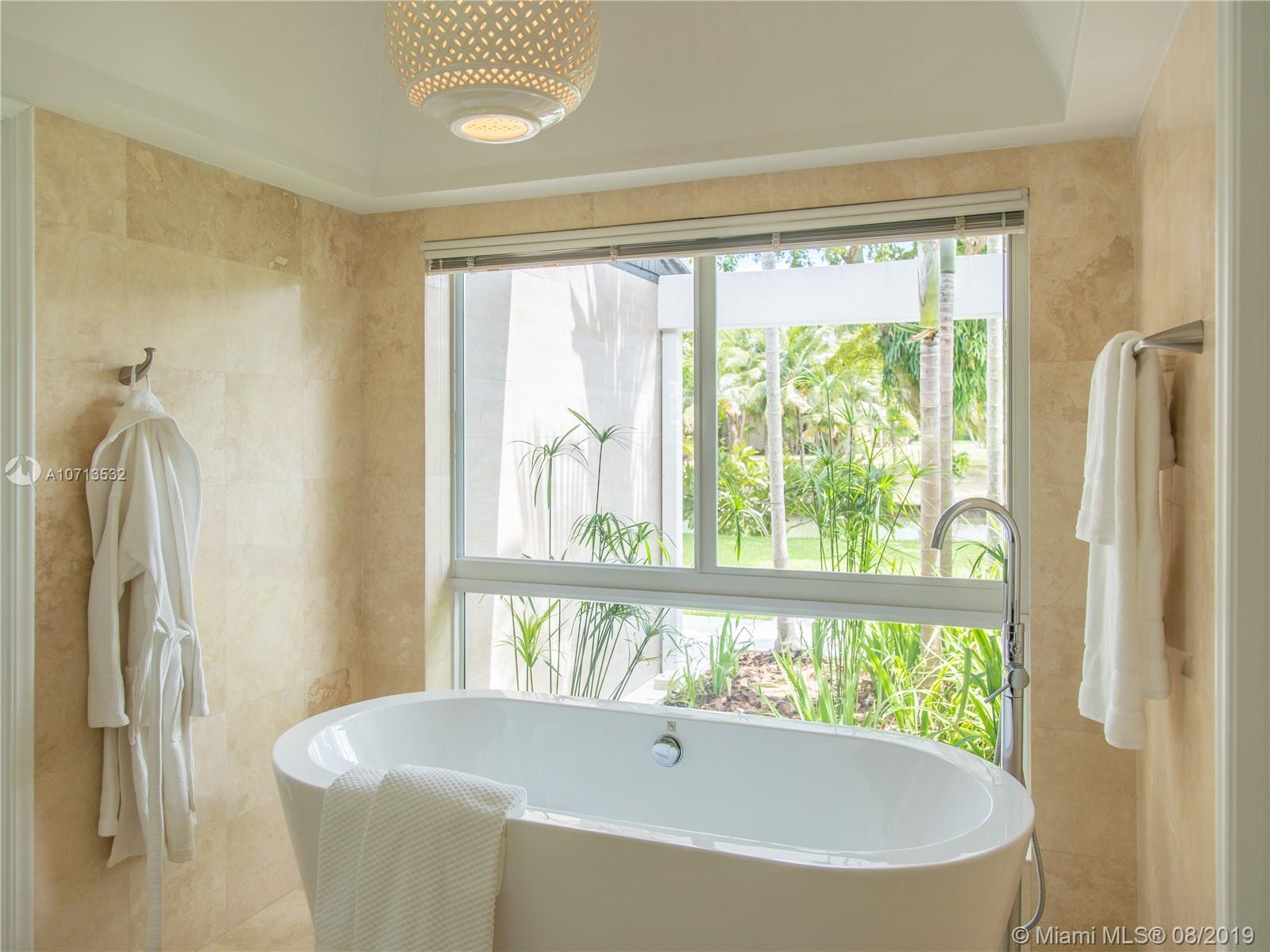 4765 Lake Road Miami, FL 33137 - Photo 21 of 30 a living room with a large window and a bed