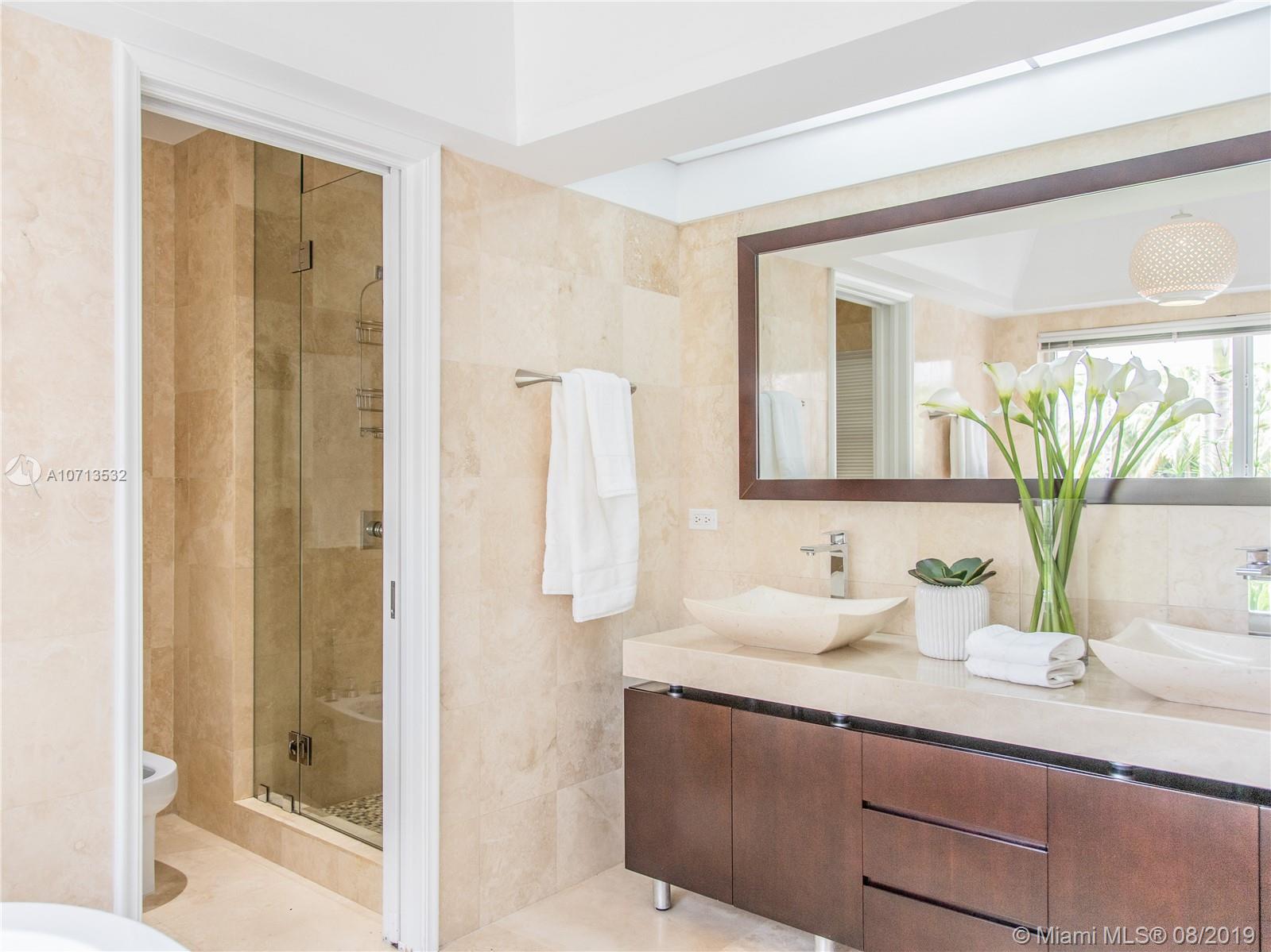 4765 Lake Road Miami, FL 33137 - Photo 22 of 30 a bathroom with a granite countertop sink and a mirror
