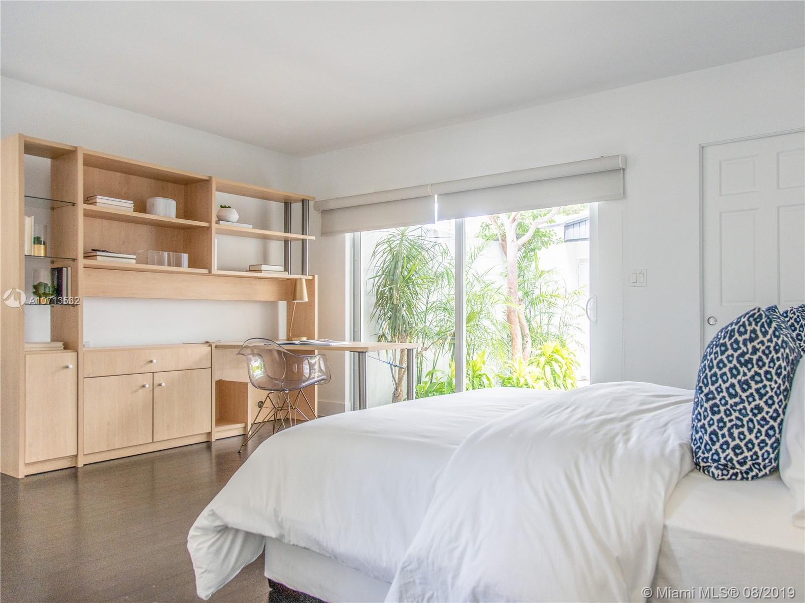 4765 Lake Road Miami, FL 33137 - Photo 23 of 30 a bedroom with a large bed and a large window