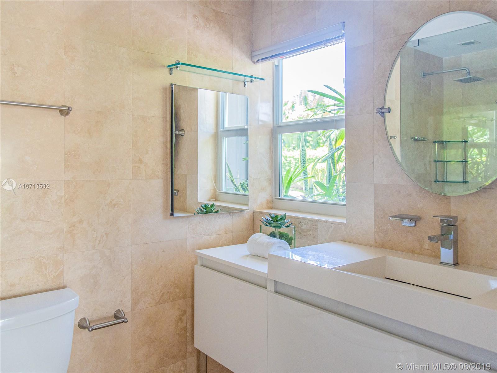 4765 Lake Road Miami, FL 33137 - Photo 24 of 30 a bathroom with a sink and a mirror