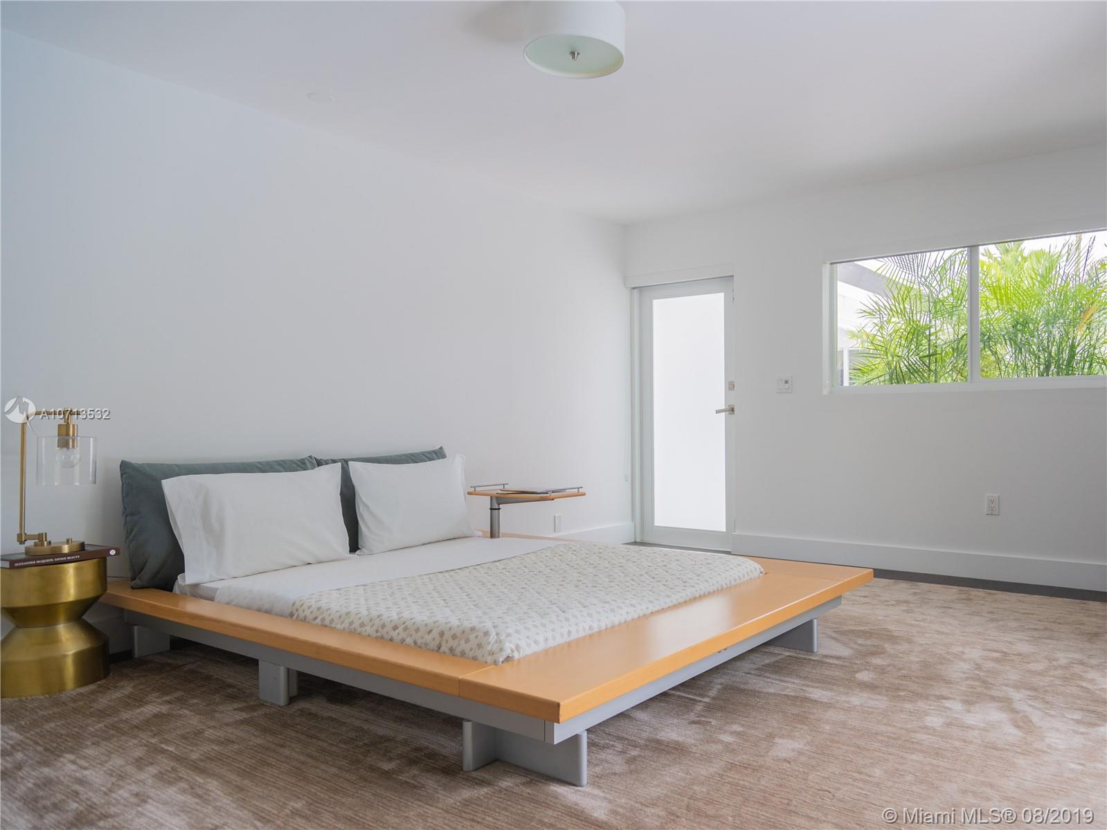 4765 Lake Road Miami, FL 33137 - Photo 25 of 30 a bedroom with a bed and window
