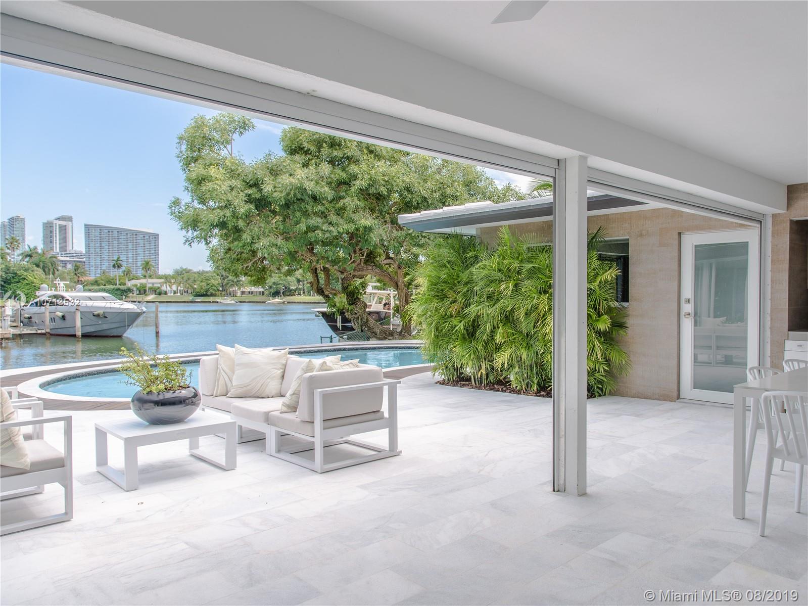 4765 Lake Road Miami, FL 33137 - Photo 29 of 30 a view of a patio with a table and chairs