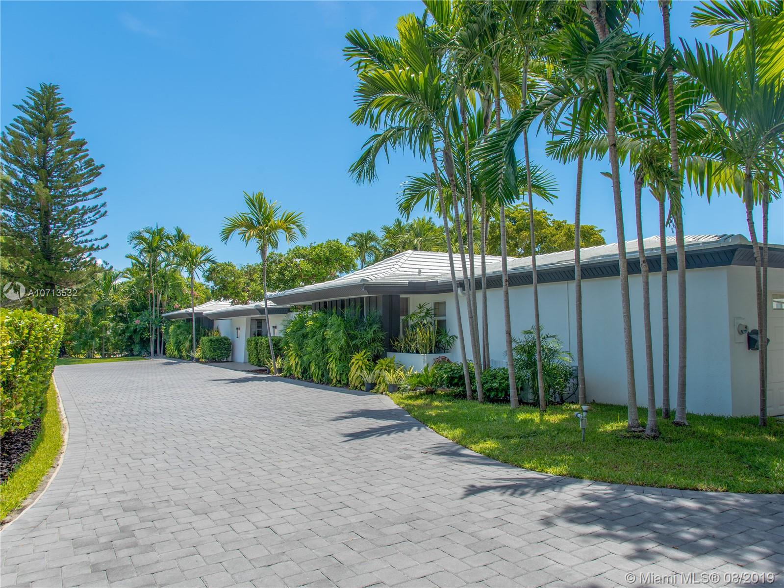 4765 Lake Road Miami, FL 33137 - Photo 8 of 30 a view of a backyard with potted plants and palm trees