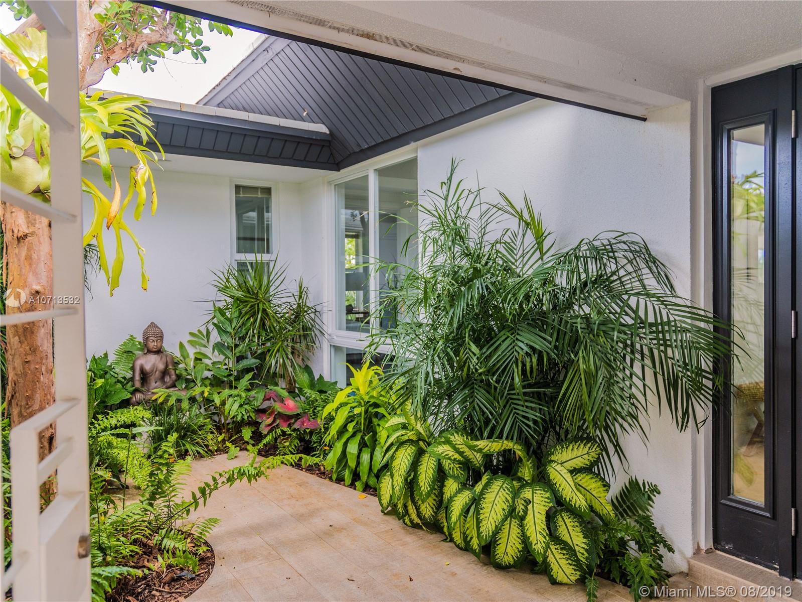 4765 Lake Road Miami, FL 33137 - Photo 9 of 30 a house with a plant in front of it