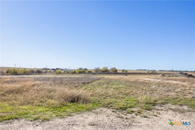 a view of a field with an ocean