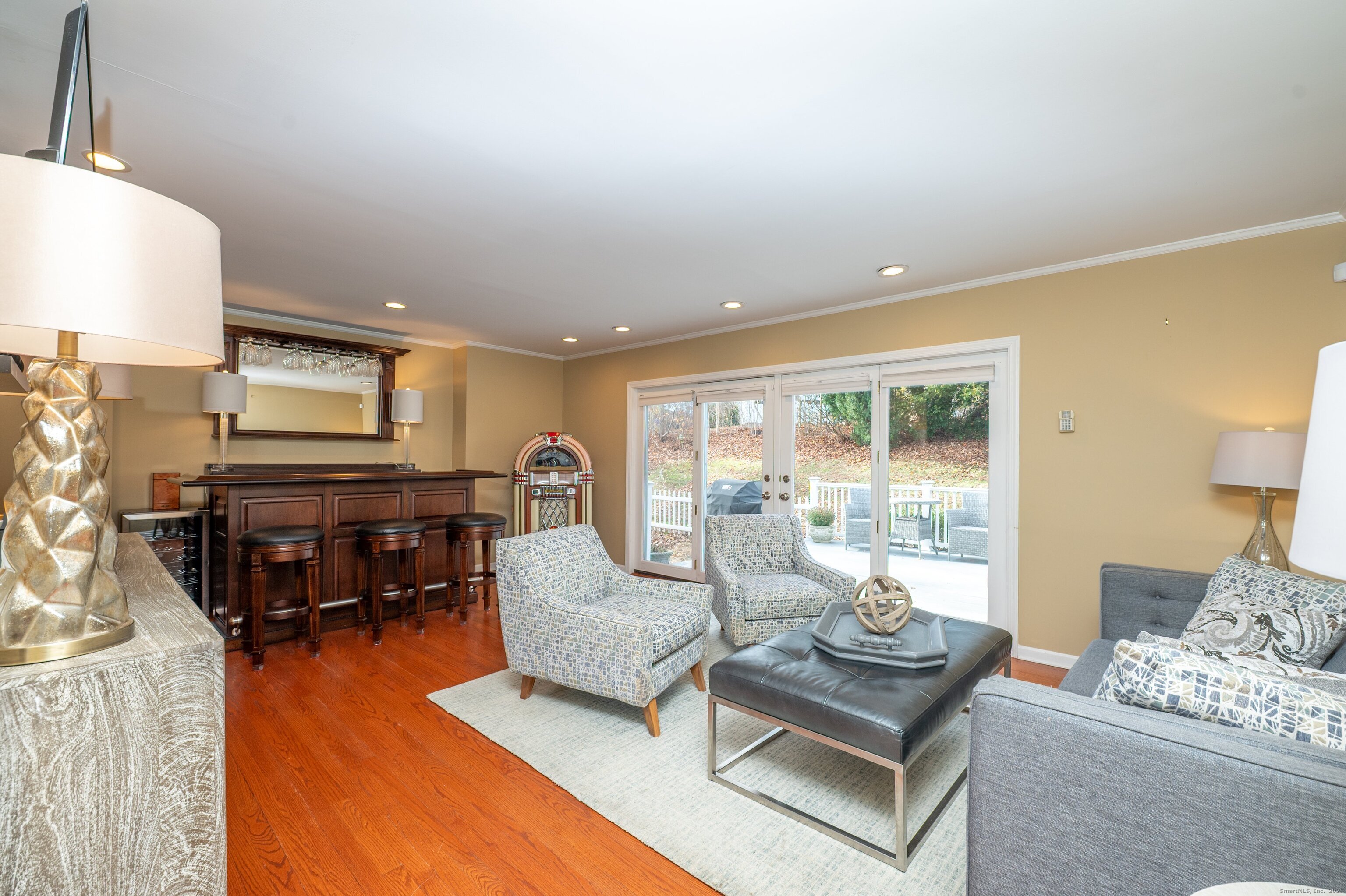 15 Griffing Pond Road Branford, CT 06405 - Photo 17 of 40 a living room with furniture and a flat screen tv with kitchen view