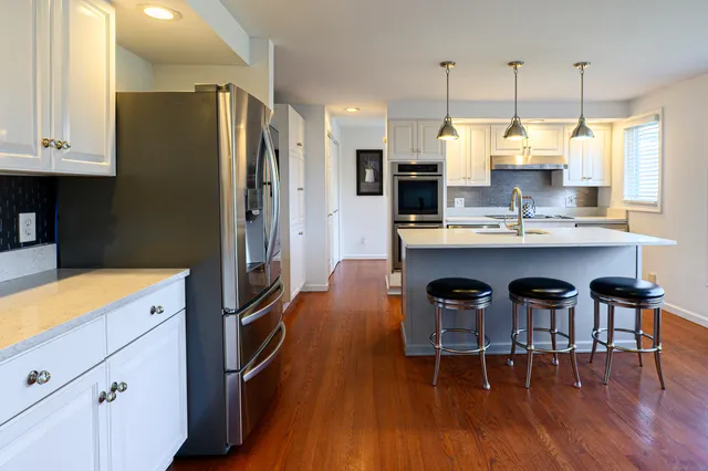 a kitchen with kitchen island a sink stove and refrigerator