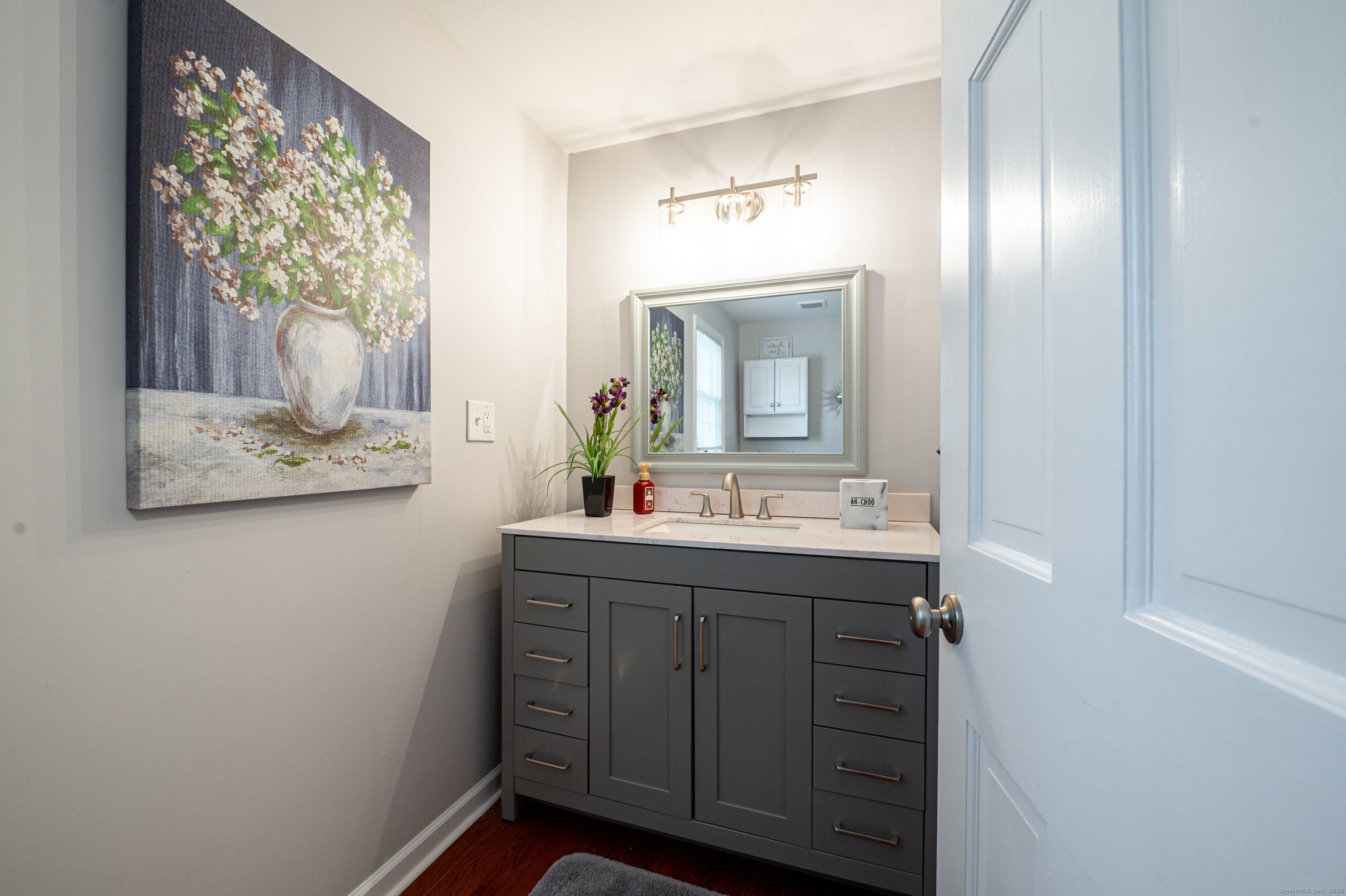 15 Griffing Pond Road Branford, CT 06405 - Photo 25 of 40 a bathroom with a sink and a mirror