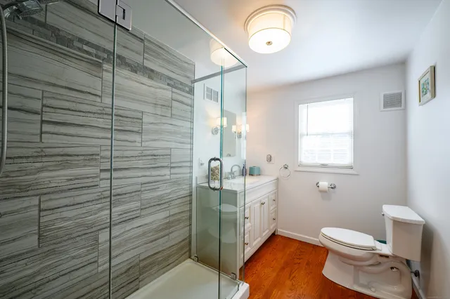 a bathroom with a toilet sink and mirror