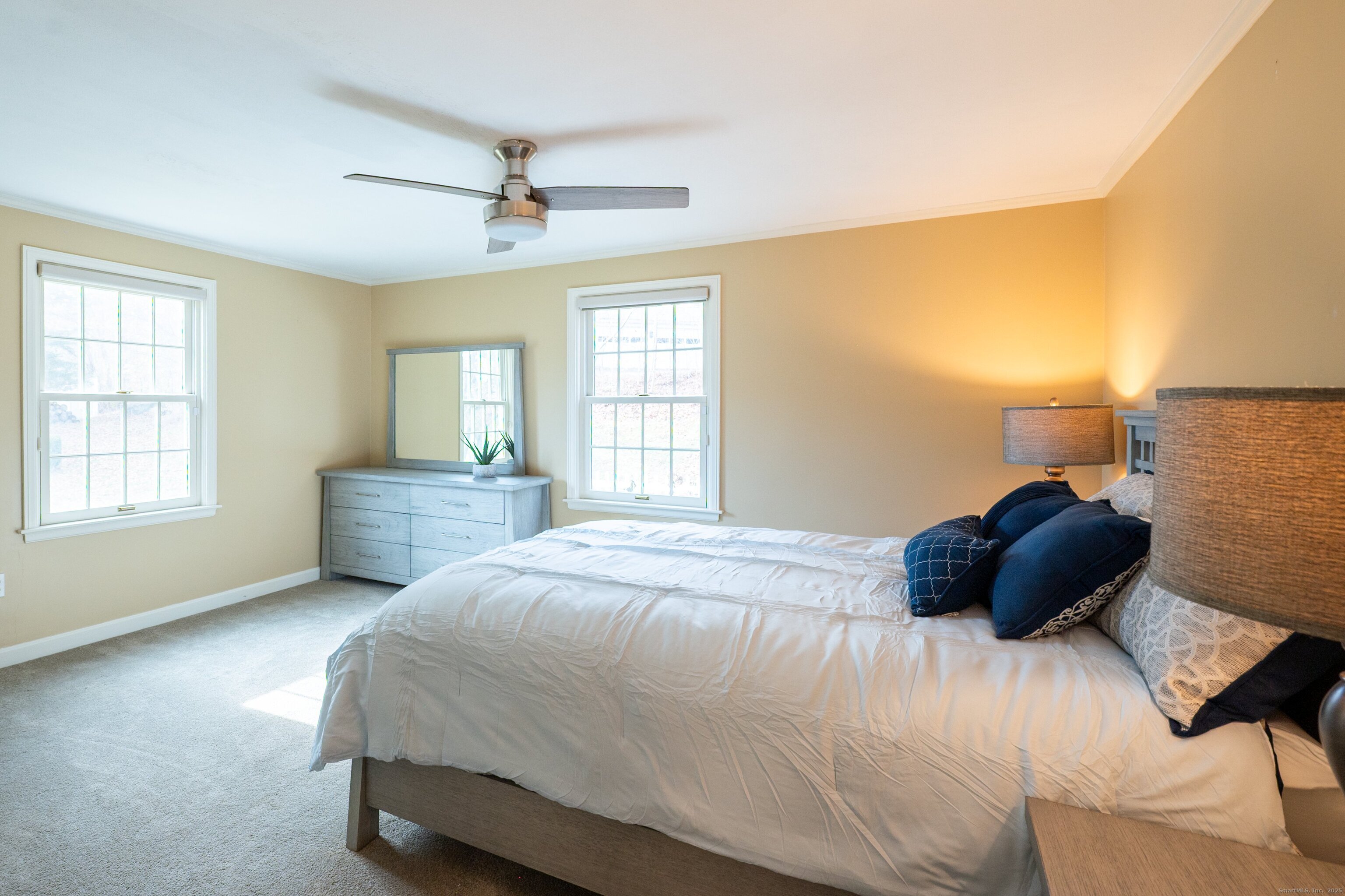 15 Griffing Pond Road Branford, CT 06405 - Photo 28 of 40 a bedroom with a bed a window and a couch