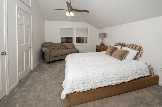 a bedroom with bed and window