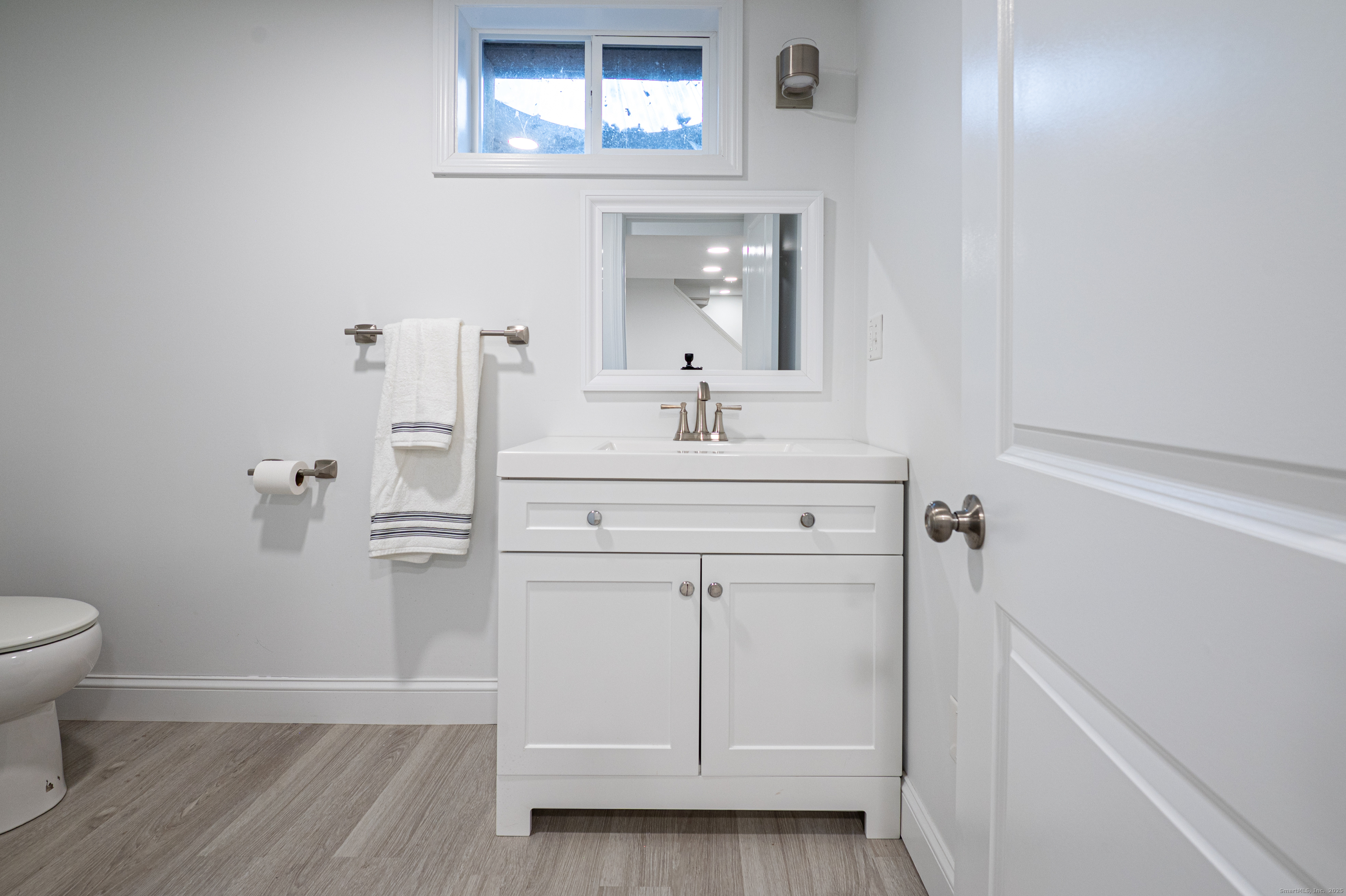 15 Griffing Pond Road Branford, CT 06405 - Photo 38 of 40 a bathroom with a sink toilet and a mirror