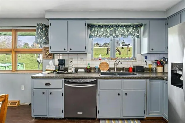 a kitchen with granite countertop white cabinets and white appliances