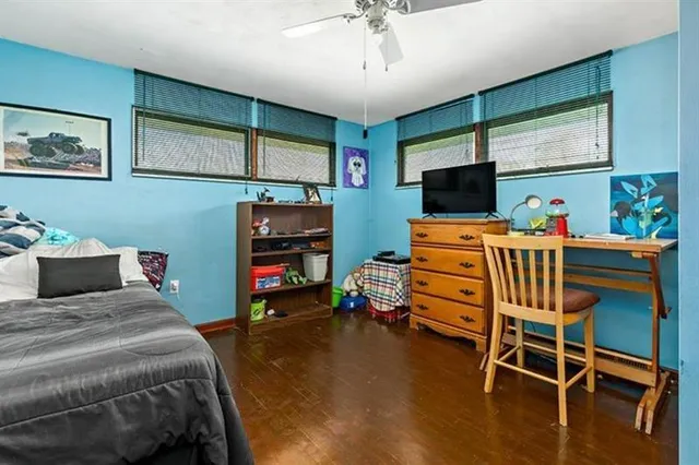 a bedroom with furniture and a flat screen tv
