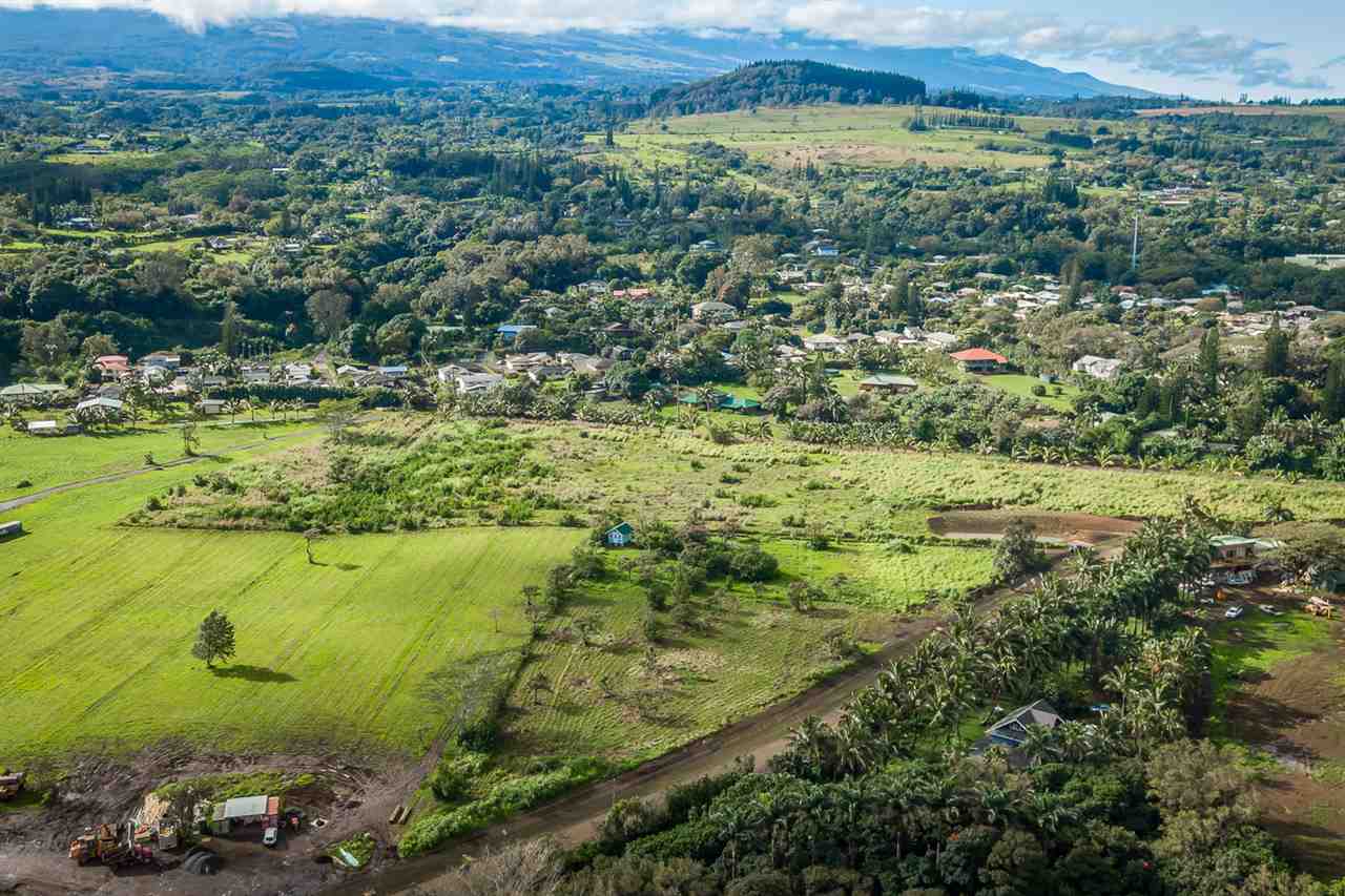 653 Kauhikoa Road, Unit A Haiku, HI 96708 - Photo 23 of 28 a view of a lush green hillside and houses