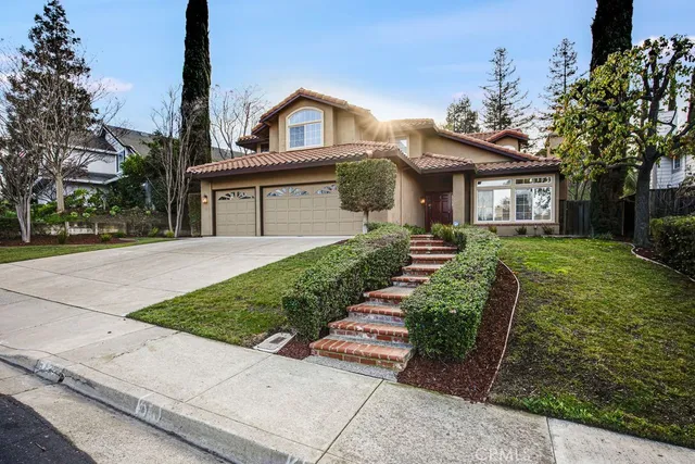 a front view of a house with a garden