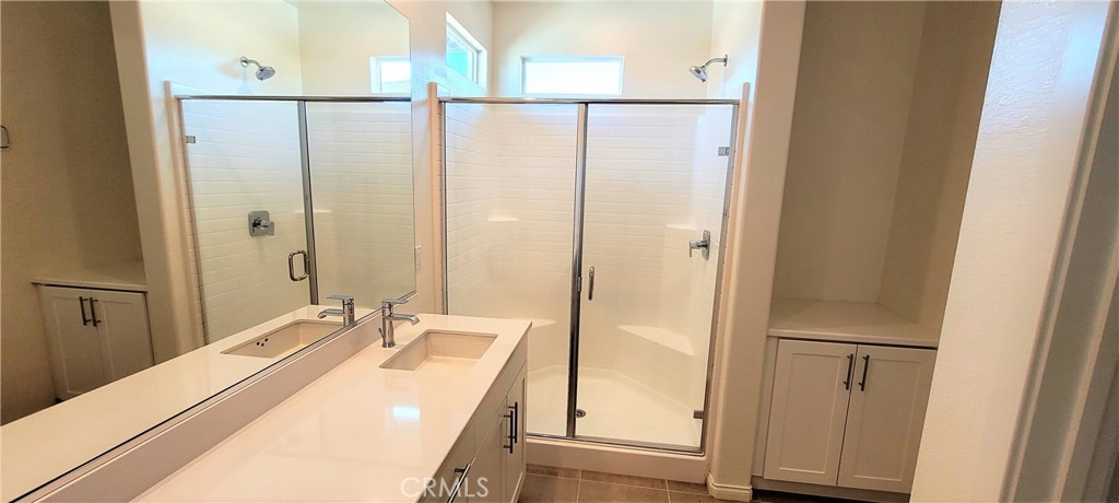 45 Aria Street South El Monte, CA 91733 - Photo 11 of 12 a bathroom with a sink mirror and shower