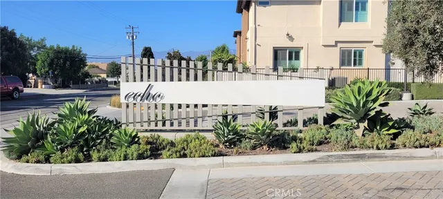 a view of a balcony with potted plants and palm trees