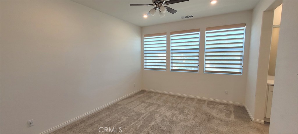 45 Aria Street South El Monte, CA 91733 - Photo 10 of 12 an empty room with a window and a fan
