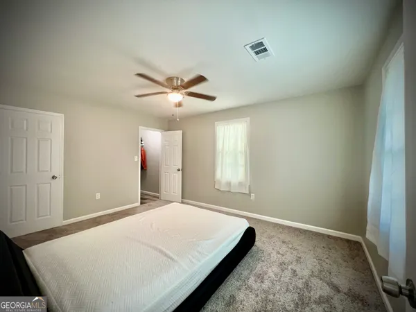 a bed room with a bed and a window