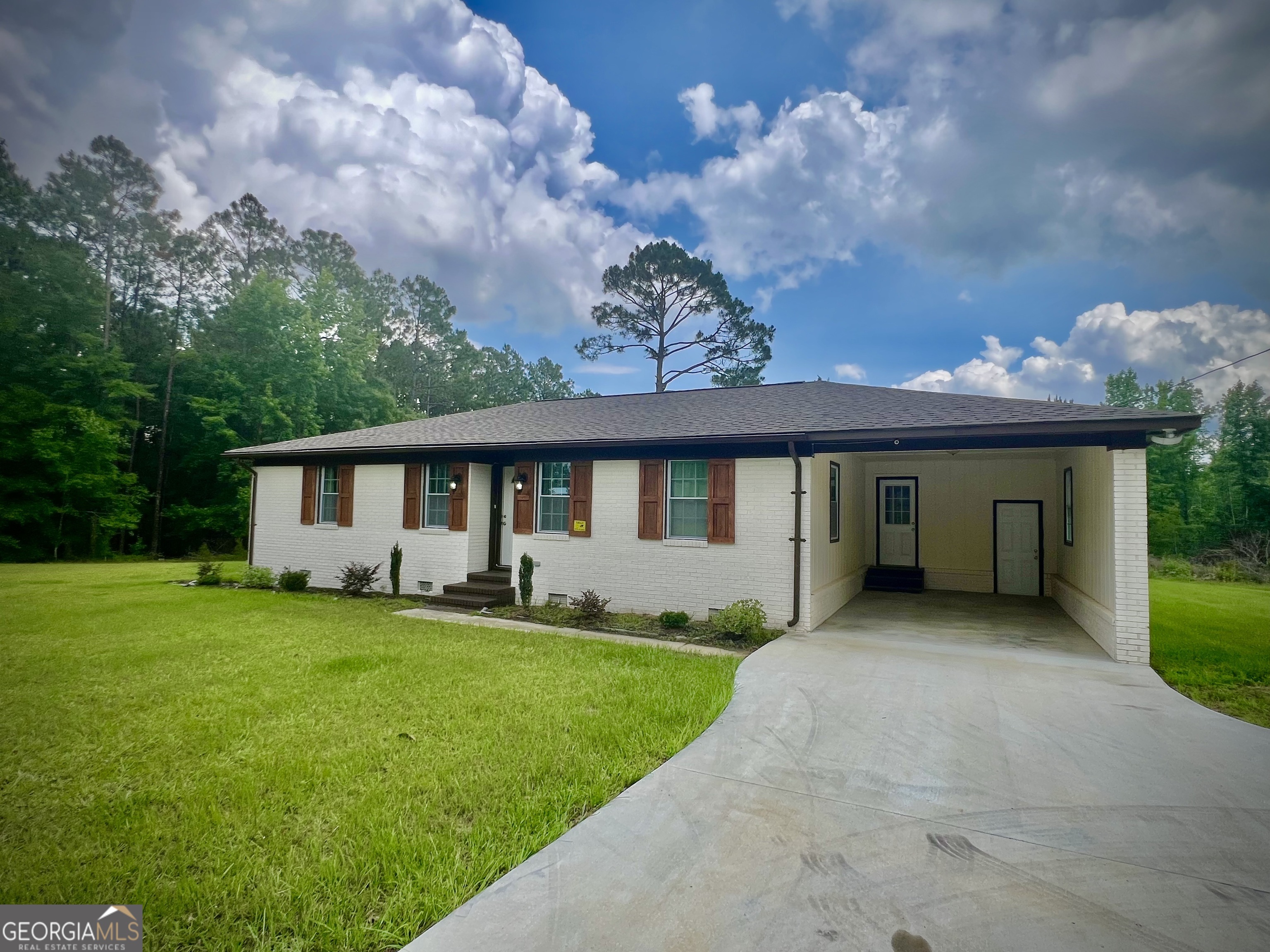1962 Anderson Road Rentz, GA 31075 - Photo 2 of 26 a front view of a house with a garden and yard