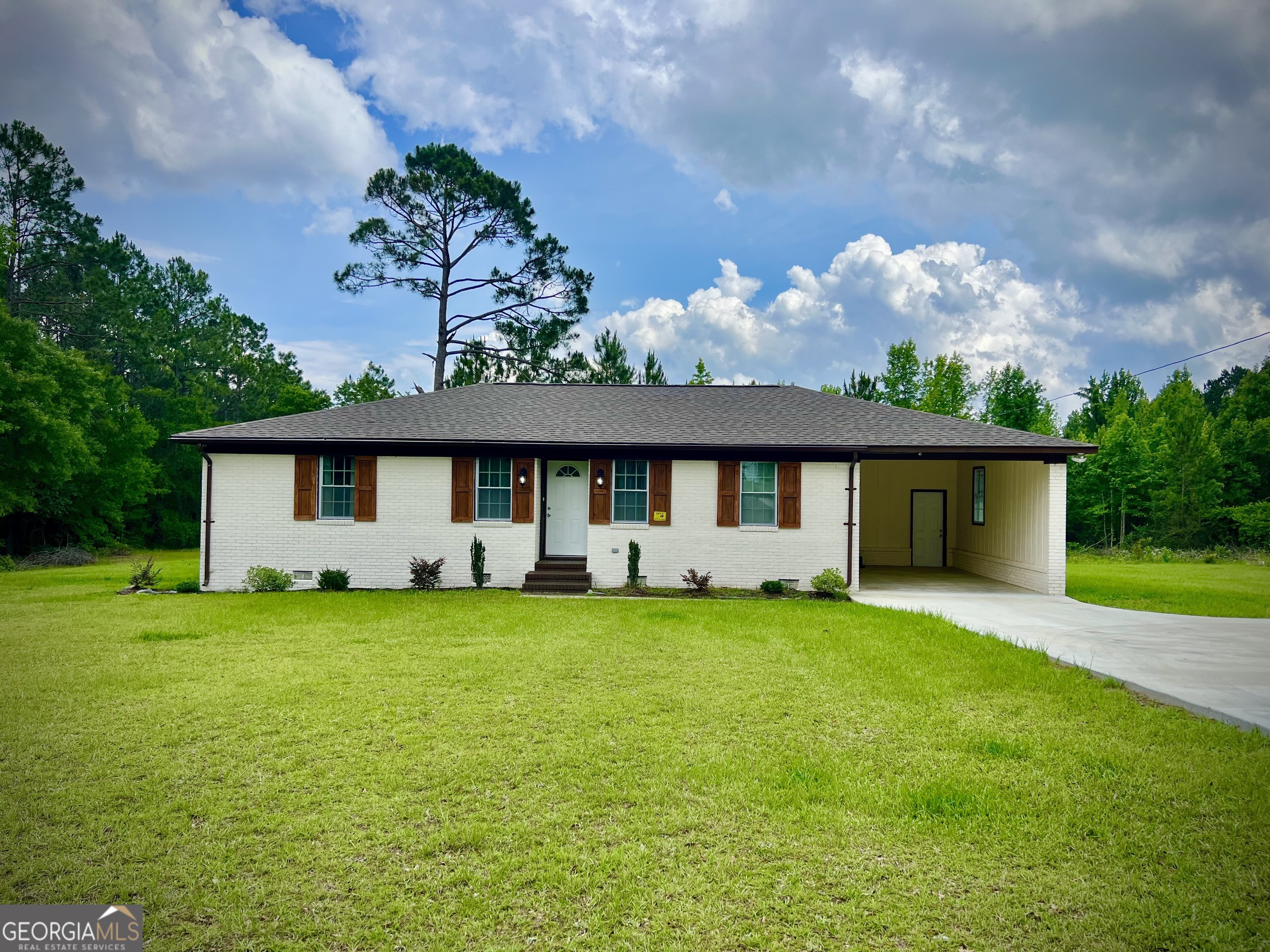 1962 Anderson Road Rentz, GA 31075 - Photo 21 of 26 a front view of a house with a garden