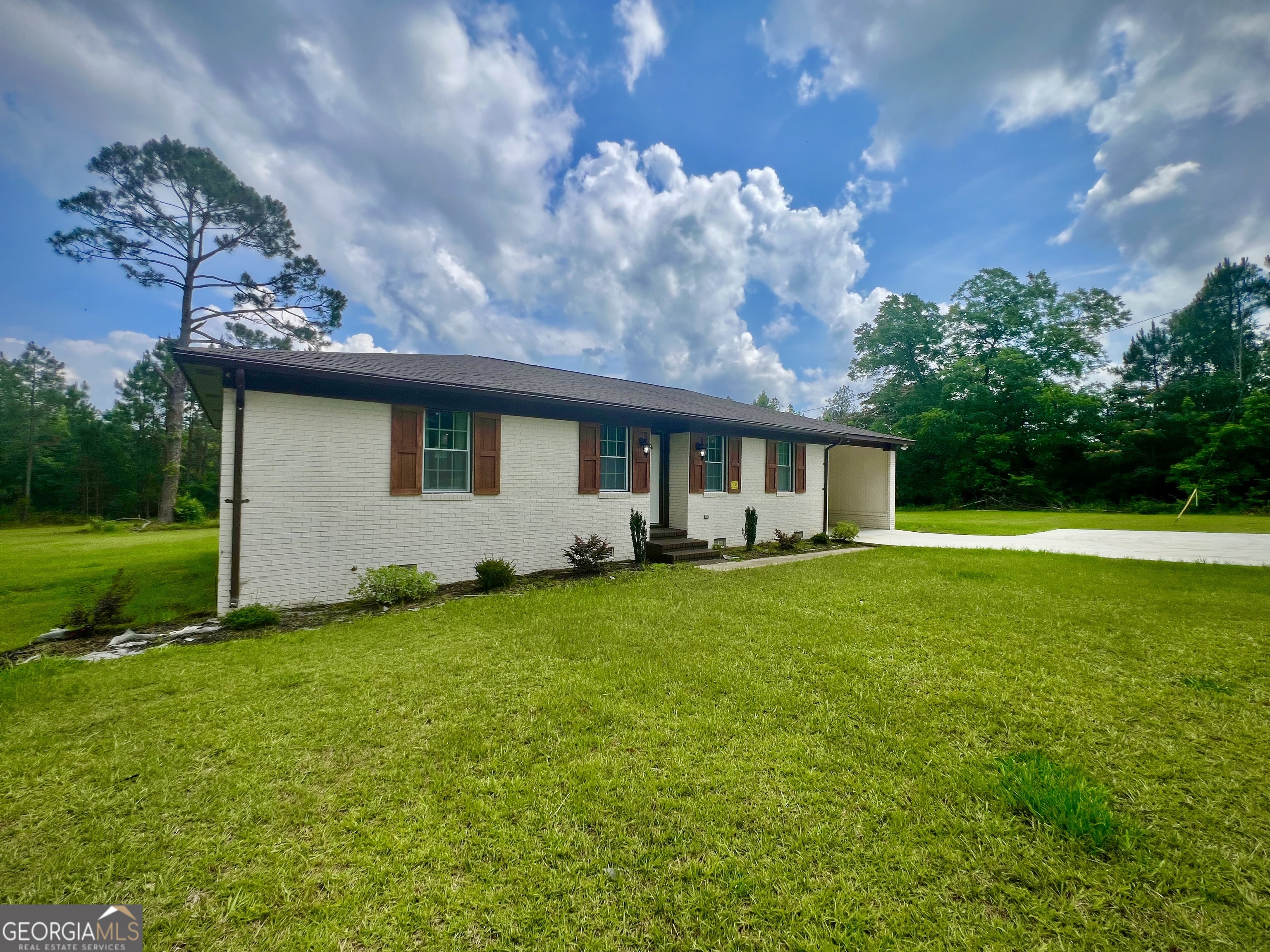 1962 Anderson Road Rentz, GA 31075 - Photo 23 of 26 a backyard of a house with table and chairs plants and large tree