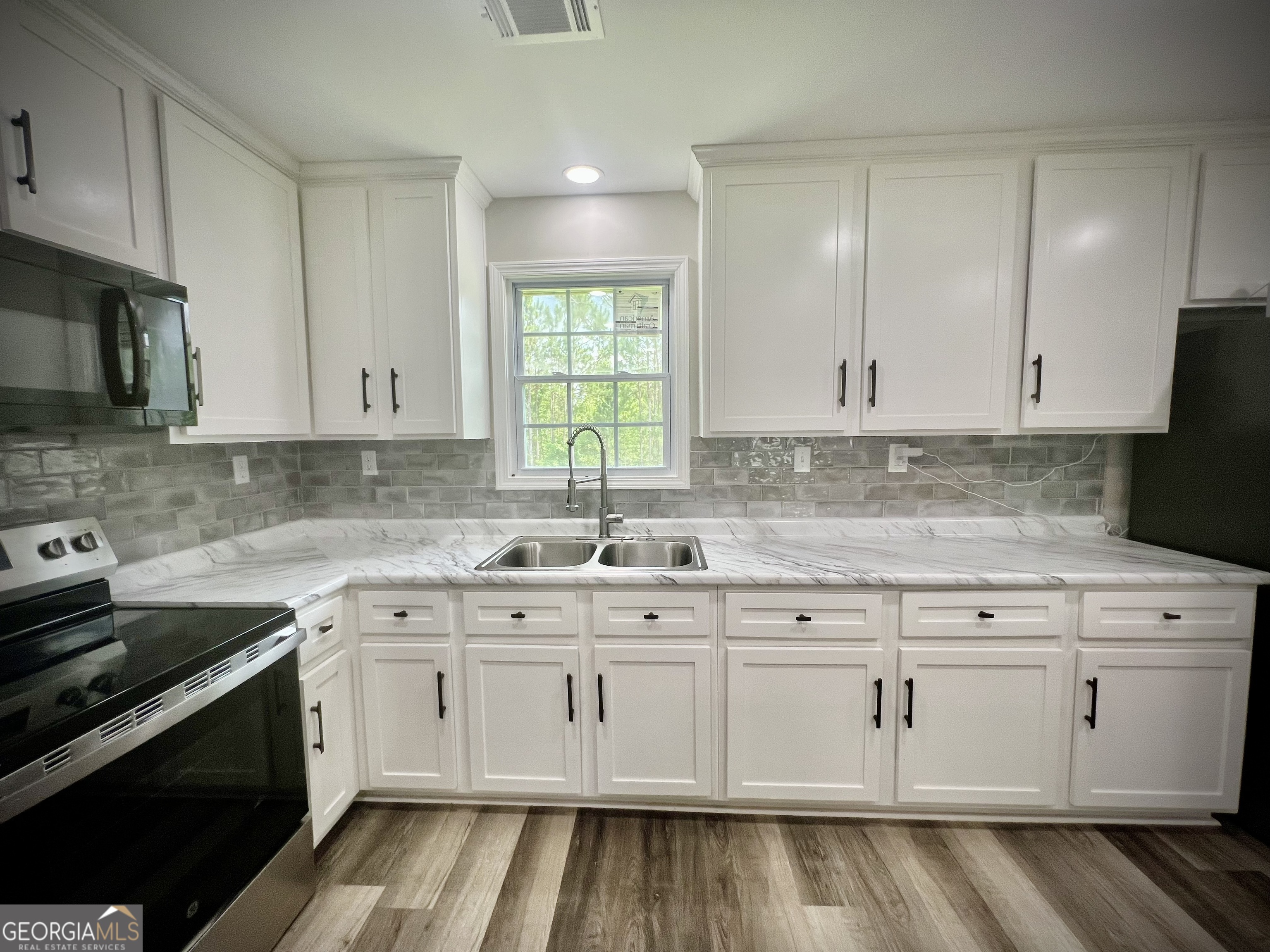 1962 Anderson Road Rentz, GA 31075 - Photo 8 of 26 a kitchen with white cabinets appliances and a sink