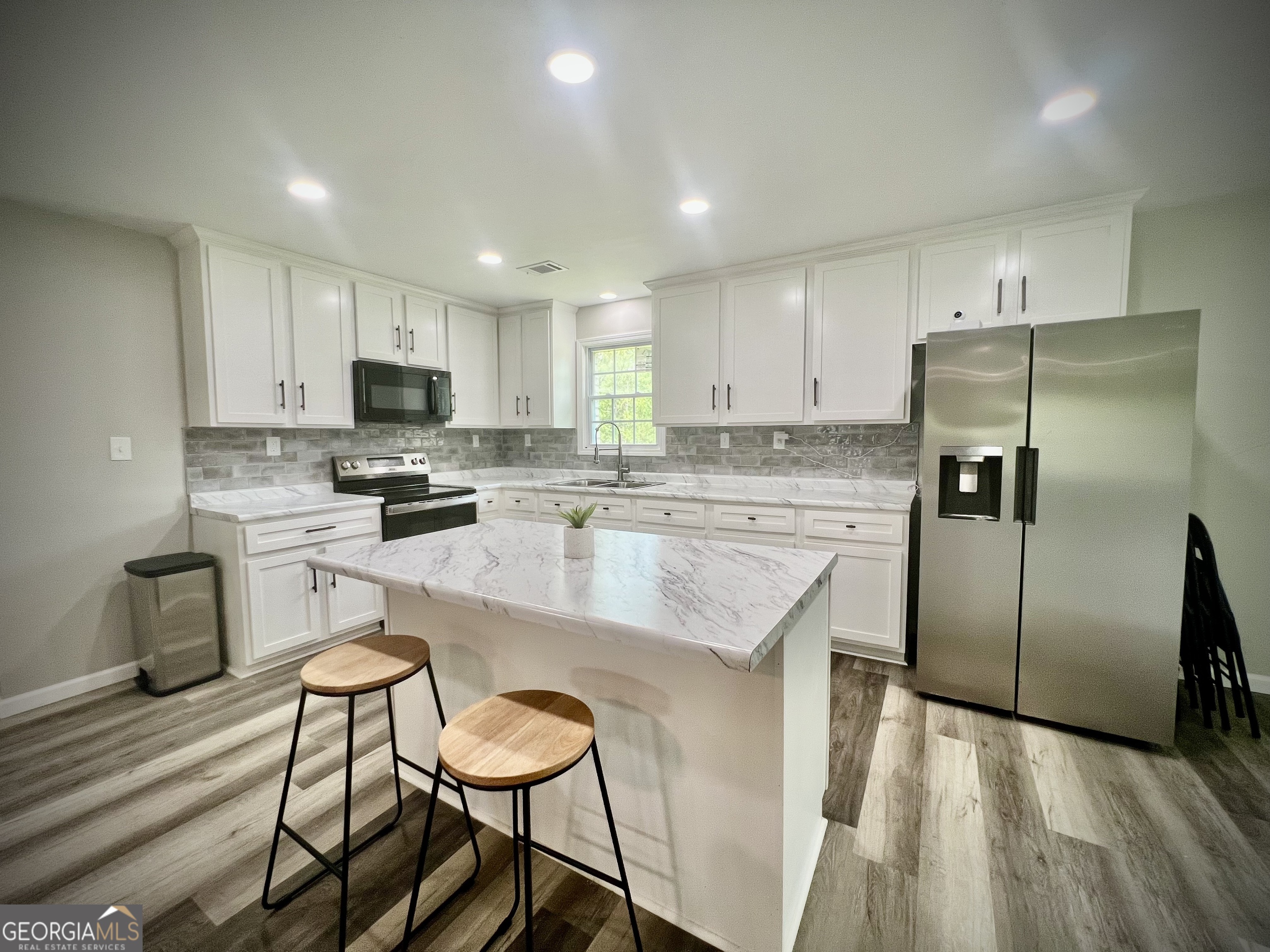 1962 Anderson Road Rentz, GA 31075 - Photo 10 of 26 a kitchen with kitchen island a refrigerator stove microwave and cabinets