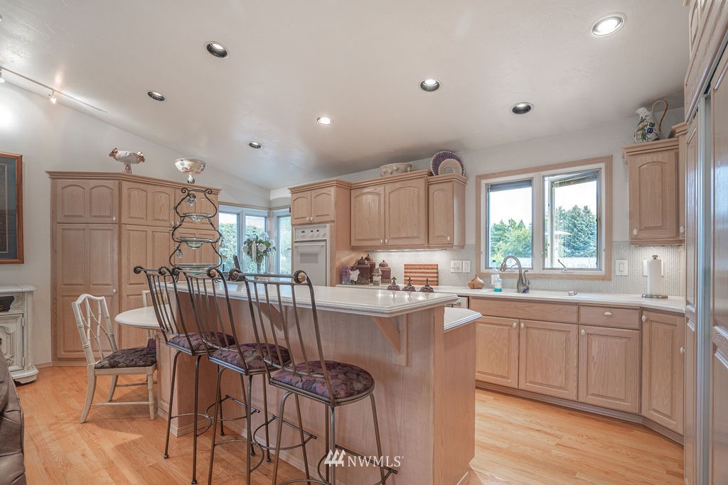 841 South Taylor Road Othello, WA 99344 - Photo 16 of 40 a kitchen with stainless steel appliances granite countertop sink a stove a dining table and chairs