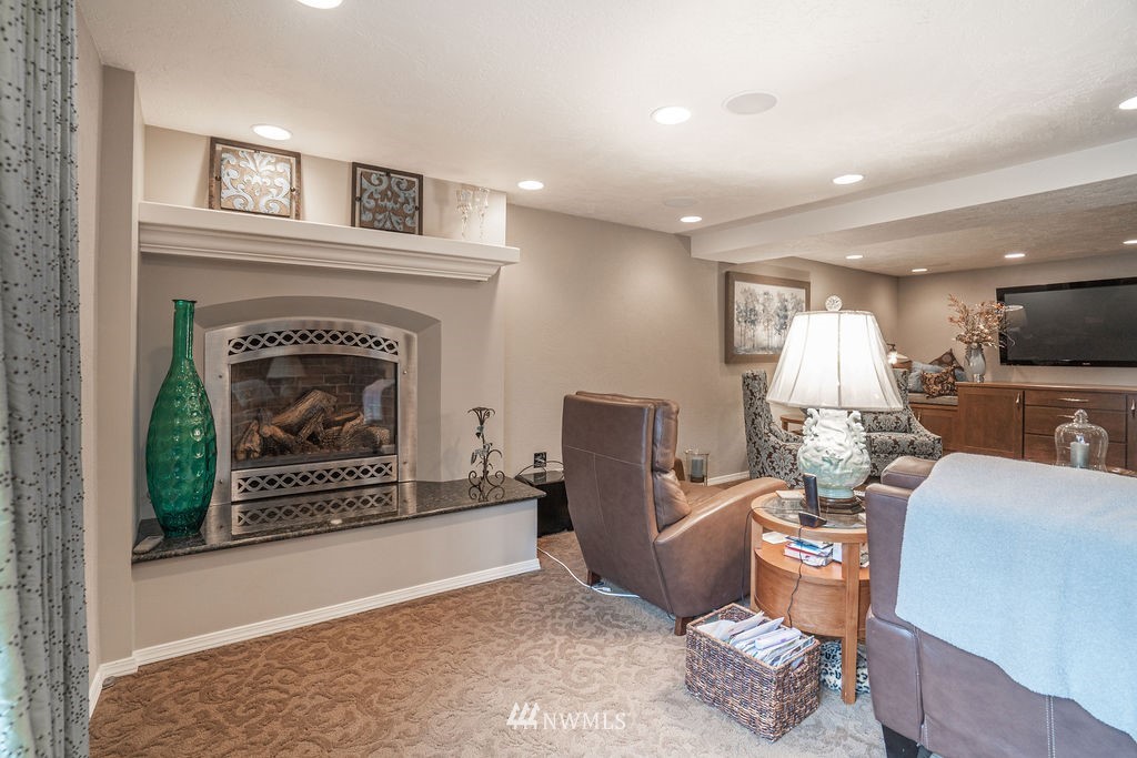 841 South Taylor Road Othello, WA 99344 - Photo 33 of 40 a living room with furniture a fireplace and a flat screen tv