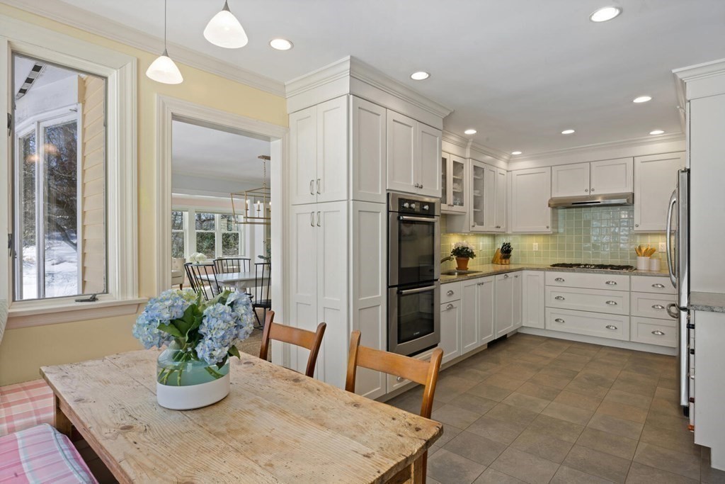410 Lowell Road Concord, MA 01742 - Photo 12 of 36 a kitchen with stainless steel appliances kitchen island granite countertop a refrigerator sink and stove