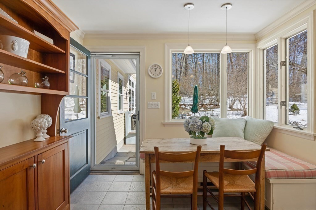 410 Lowell Road Concord, MA 01742 - Photo 14 of 36 a dining room with furniture a chandelier and window
