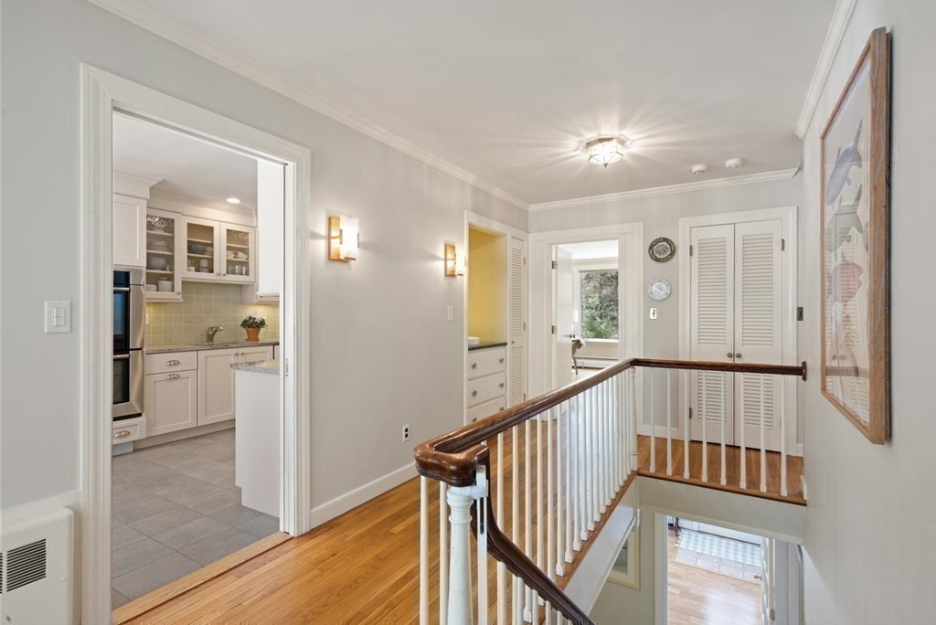 410 Lowell Road Concord, MA 01742 - Photo 21 of 36 a view of a hallway with wooden floor and staircase