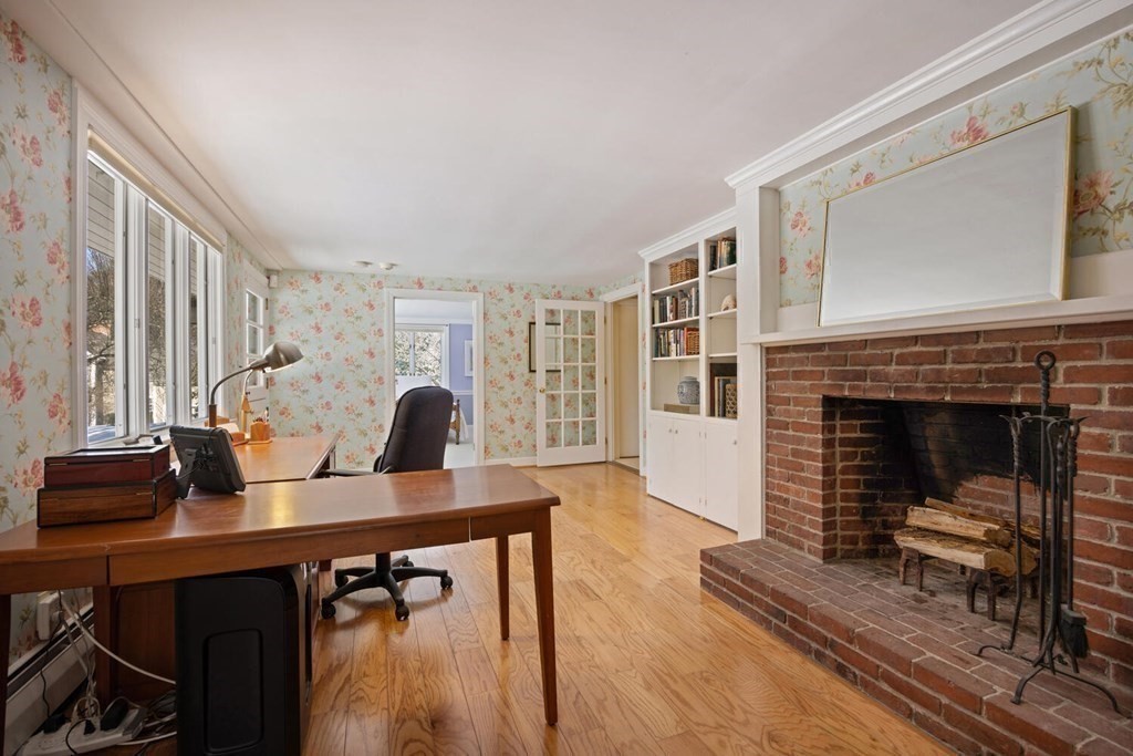 410 Lowell Road Concord, MA 01742 - Photo 22 of 36 a living room with furniture and a fireplace