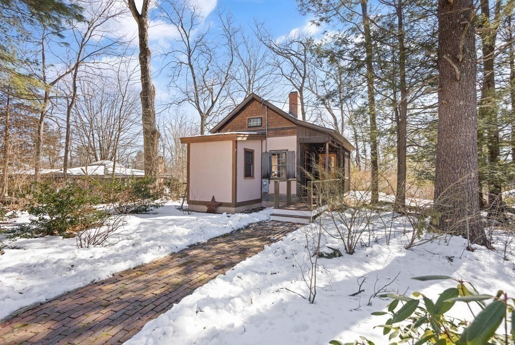 410 Lowell Road Concord, MA 01742 - Photo 27 of 36 a front view of a house with a yard covered in snow