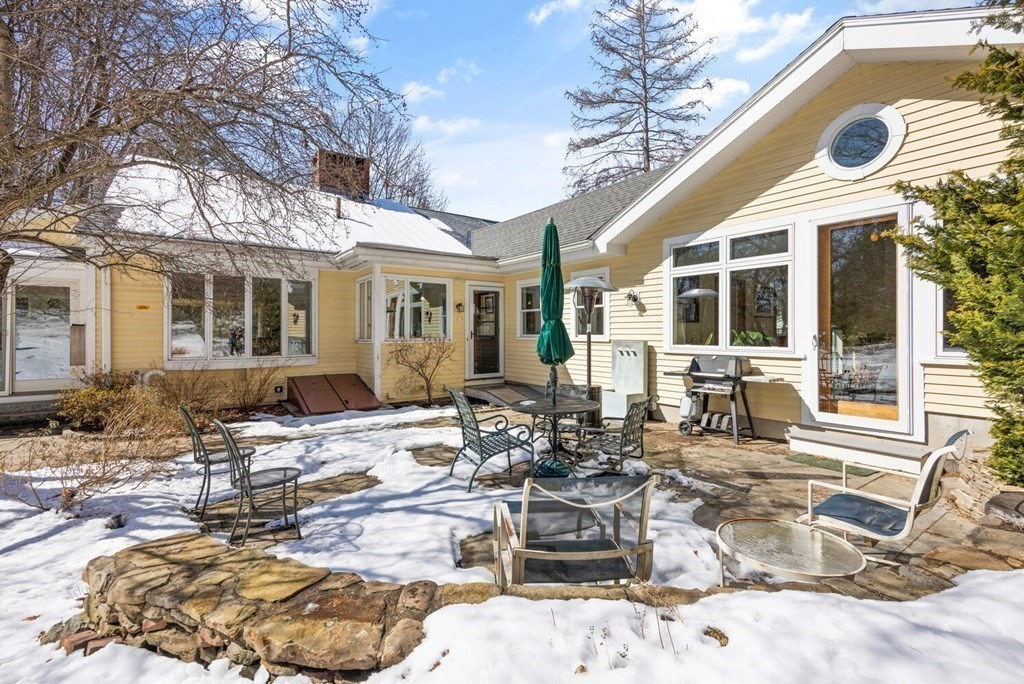 410 Lowell Road Concord, MA 01742 - Photo 34 of 36 a view of a dinning table and chairs in the patio of the house