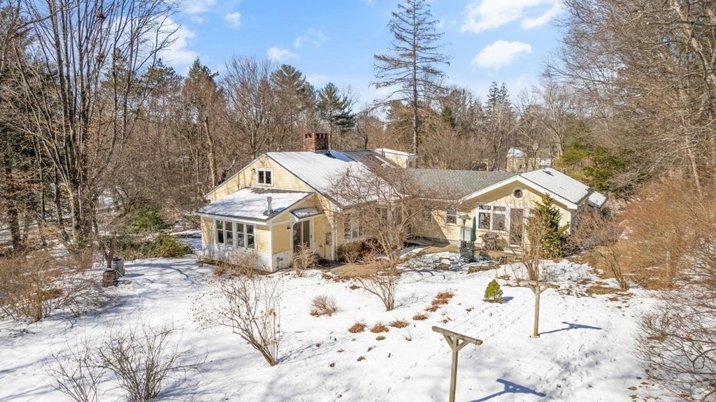 410 Lowell Road Concord, MA 01742 - Photo 35 of 36 a view of a house with a yard covered in snow