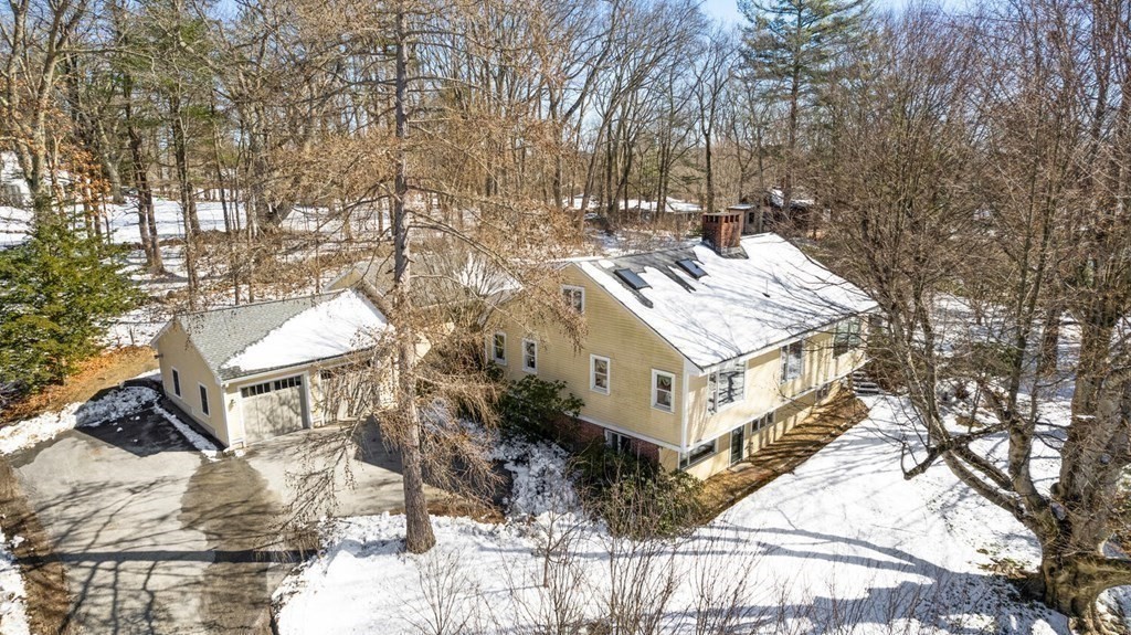 410 Lowell Road Concord, MA 01742 - Photo 36 of 36 a view of a house with a yard covered in snow