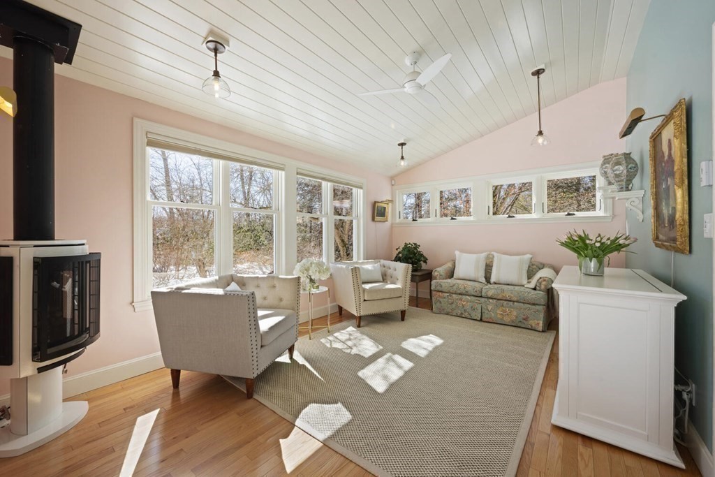 410 Lowell Road Concord, MA 01742 - Photo 10 of 36 a living room with furniture a flat screen tv and a large window