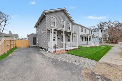 a view of a house with a yard and pathway