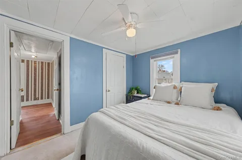 a bedroom with a large bed and a chandelier