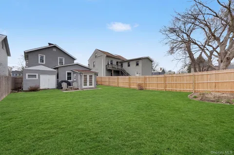 a view of a house with a yard and sitting area