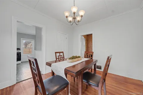 a view of a dining room with furniture wooden floor and a chandelier